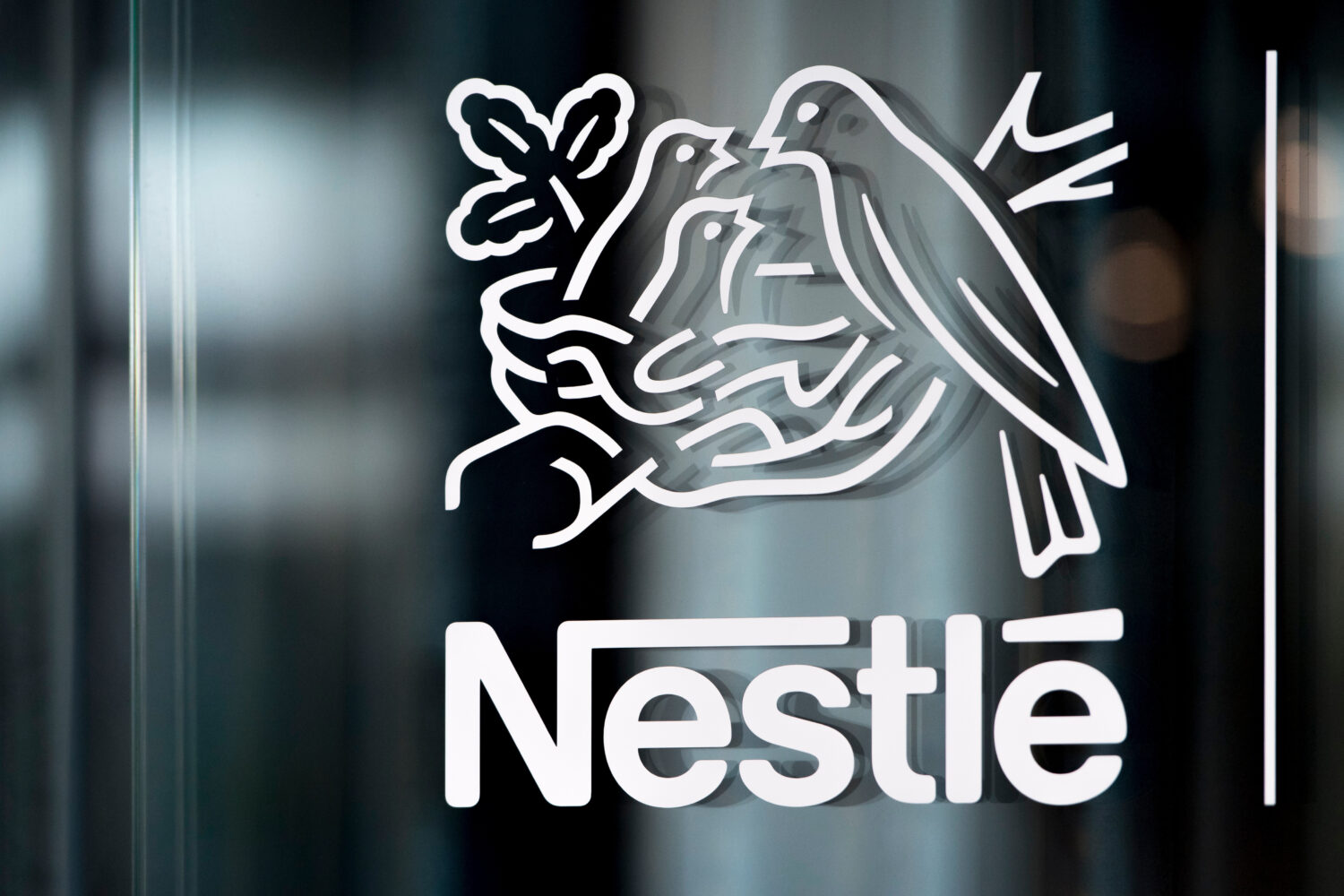 FILE - In this Thursday, Feb. 14, 2019, file photo, Nestle's logo is displayed on a window, during ...