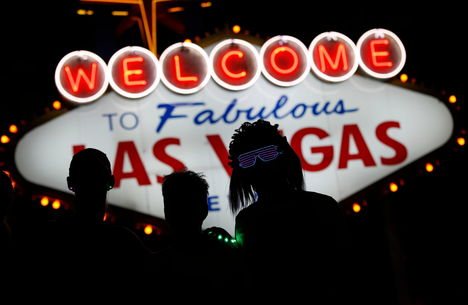 FILE - Runners stop to to have photos taken by official photographers at the Welcome to Las Vegas s...