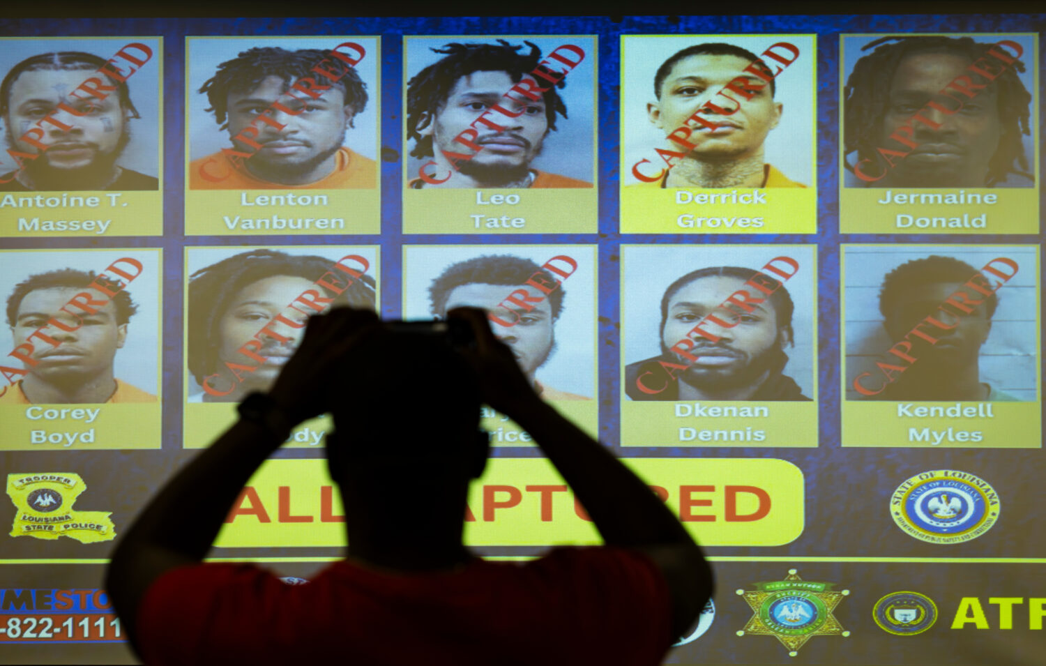 Media take photos of a display showing the captured inmates who broke out of prison months ago at L...