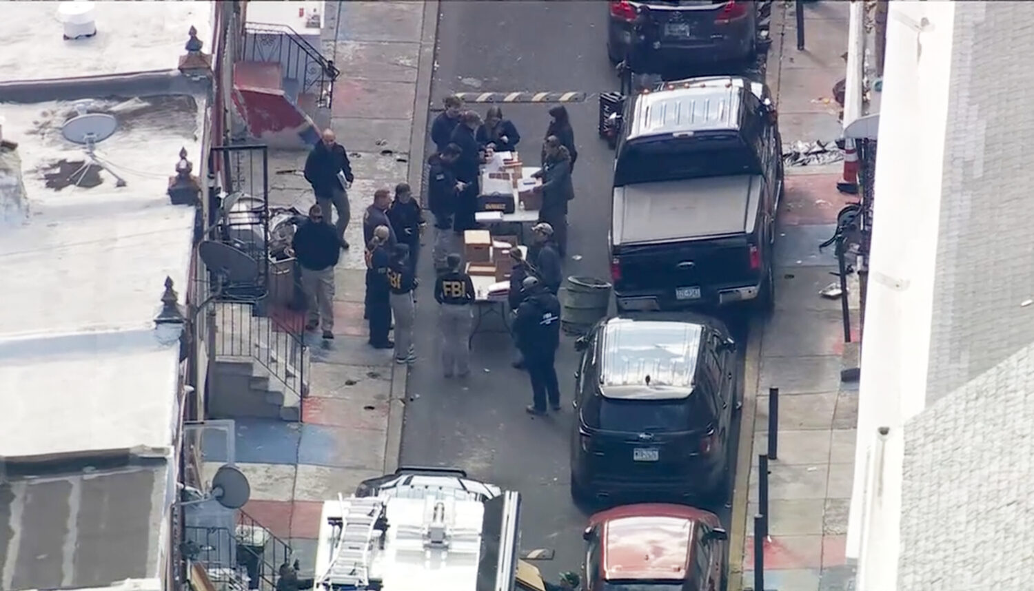 FBI agents are outside a building after a raid in the Kensington section of Philadelphia on Friday,...
