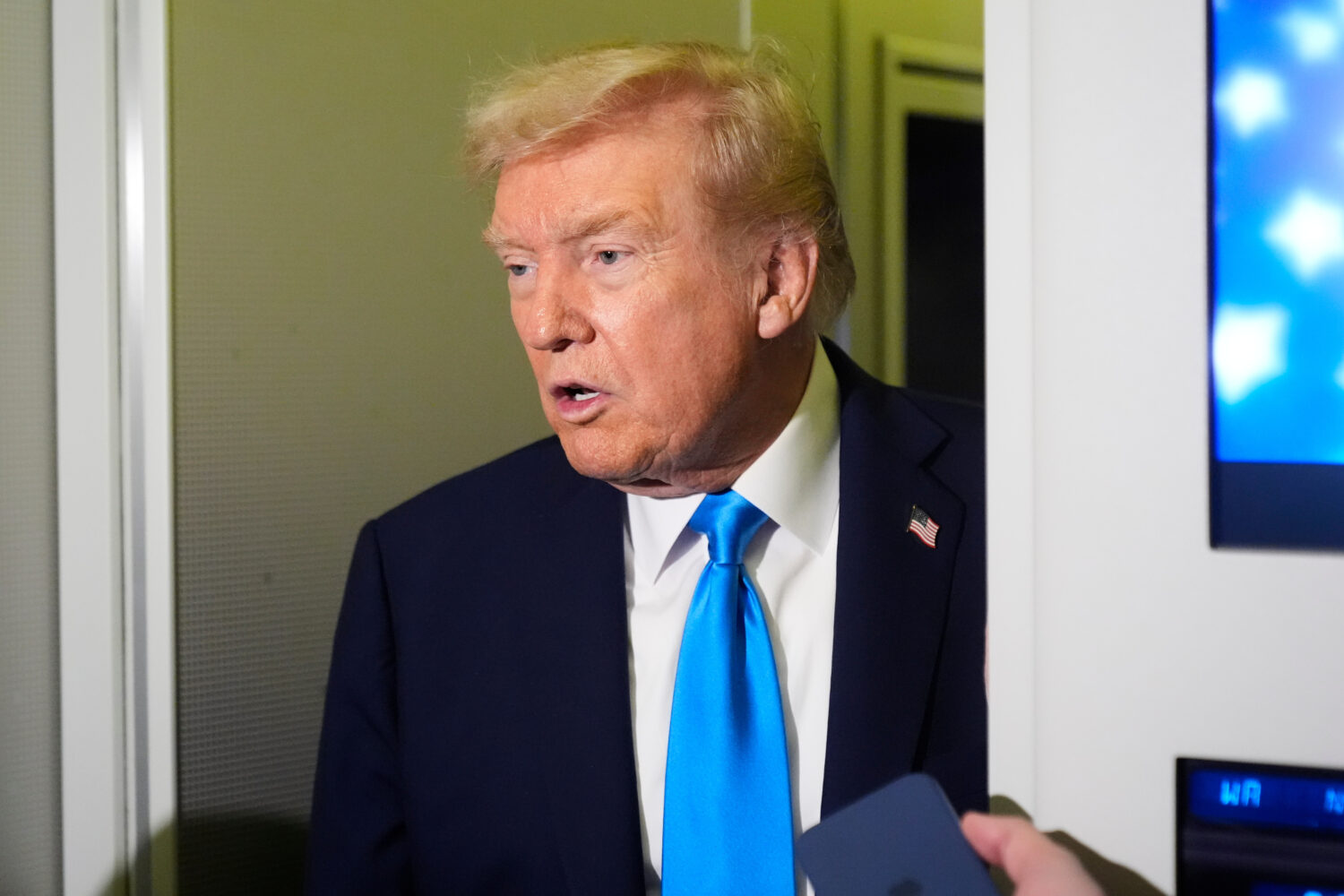 President Donald Trump speaks with reporters aboard Air Force One at Al Udeid Air Base in Doha, Qat...