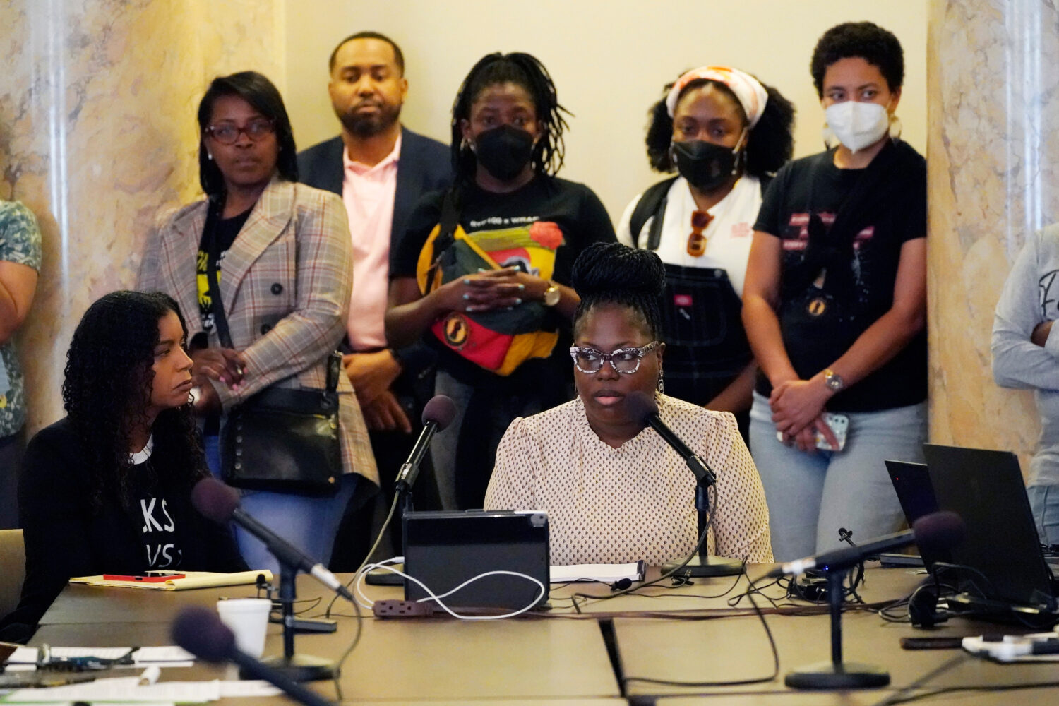 FILE - Arkela Lewis, bottom right, mother of Jaylen Lewis, who was shot to death during an encounte...