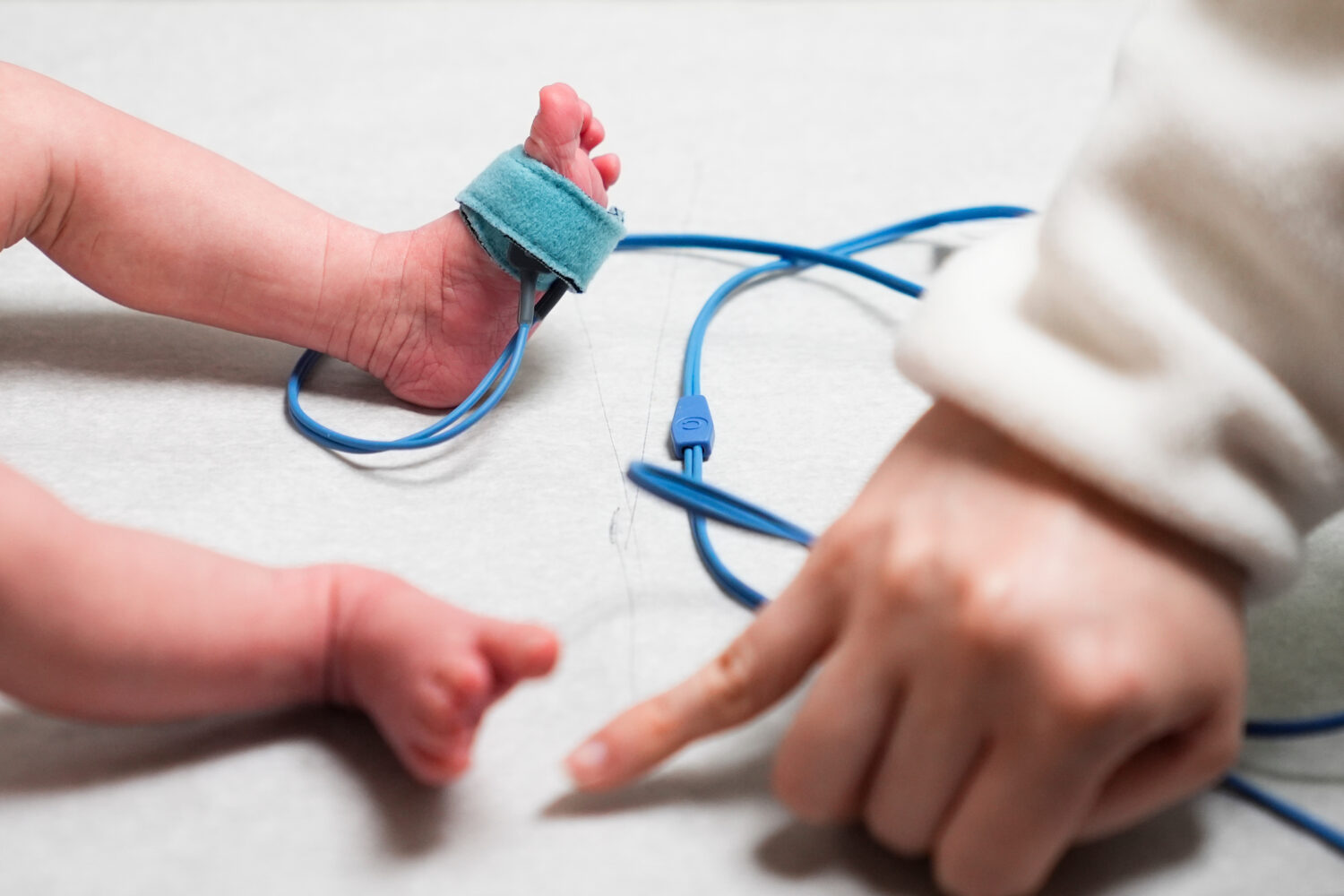 FILE - A medical assistant takes the pulse of a one month-old patient during a checkup at the Seatt...