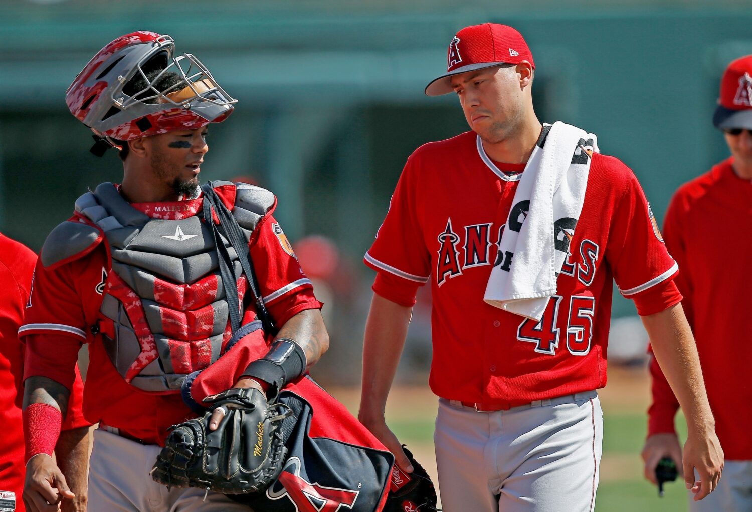 FILE - Los Angeles Angels starting pitcher Tyler Skaggs (45) talks with catcher Martin Maldonado, l...