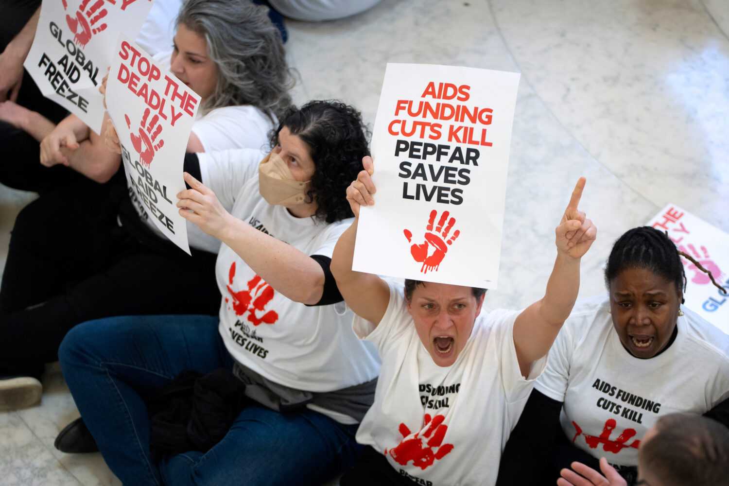 FILE - Demonstrators protest against cuts to American foreign aid spending, including USAID and the...