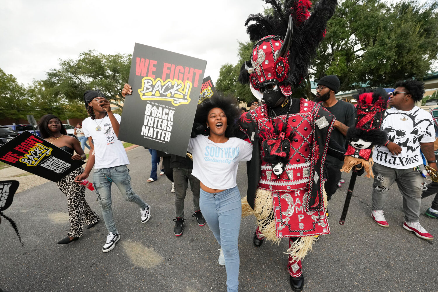 FILE - Students and a member of the Zulu Tramps march to a campus polling place on Election Day at ...