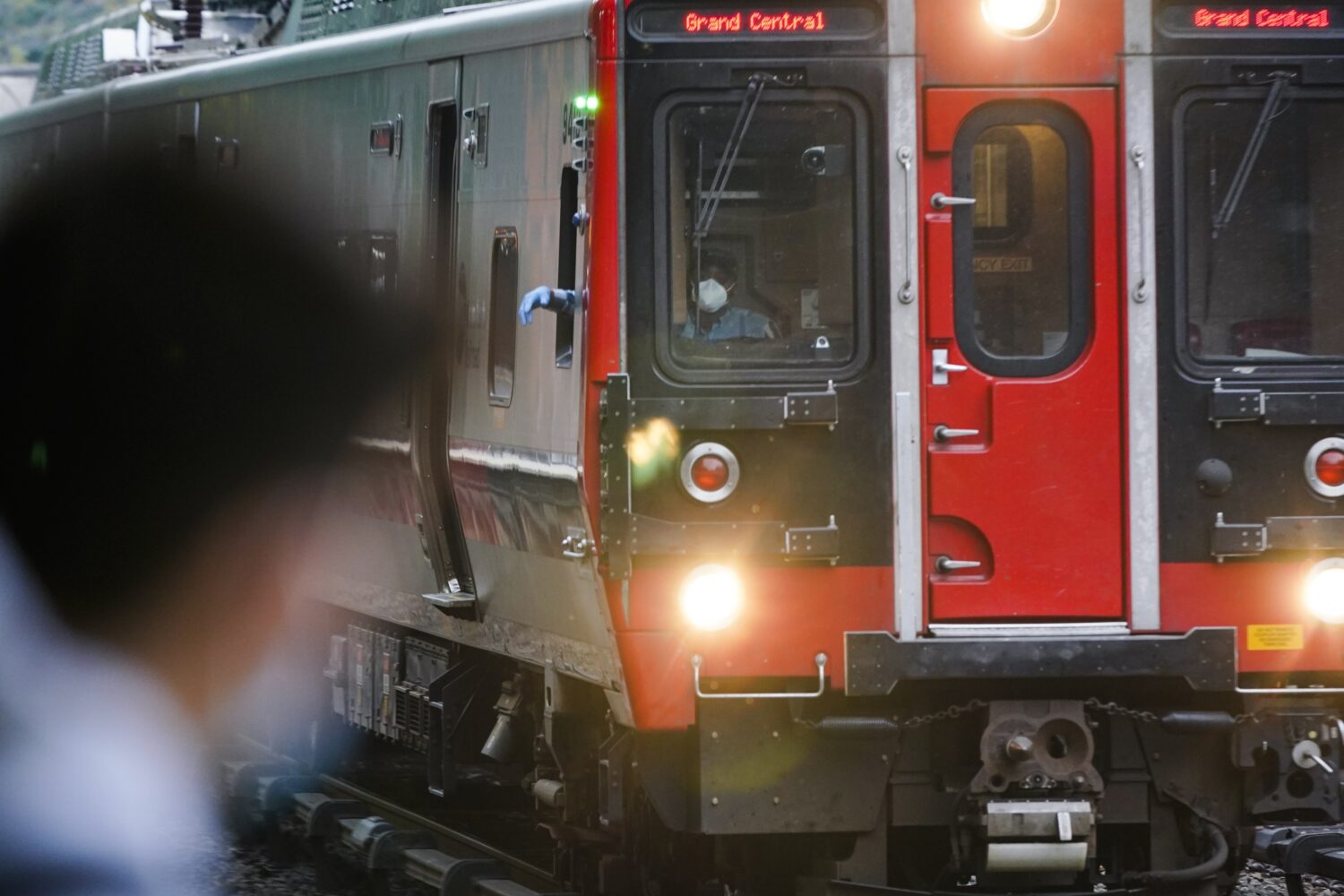FILE - A train operator watches a train at the Fordham Metro North station Thursday, Oct. 22, 2020,...