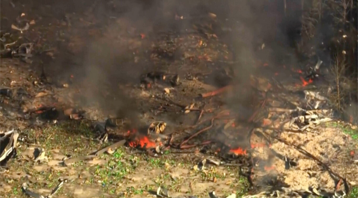 Smoke fills the air as debris covers the ground and vehicles after a powerful blast ripped through ...