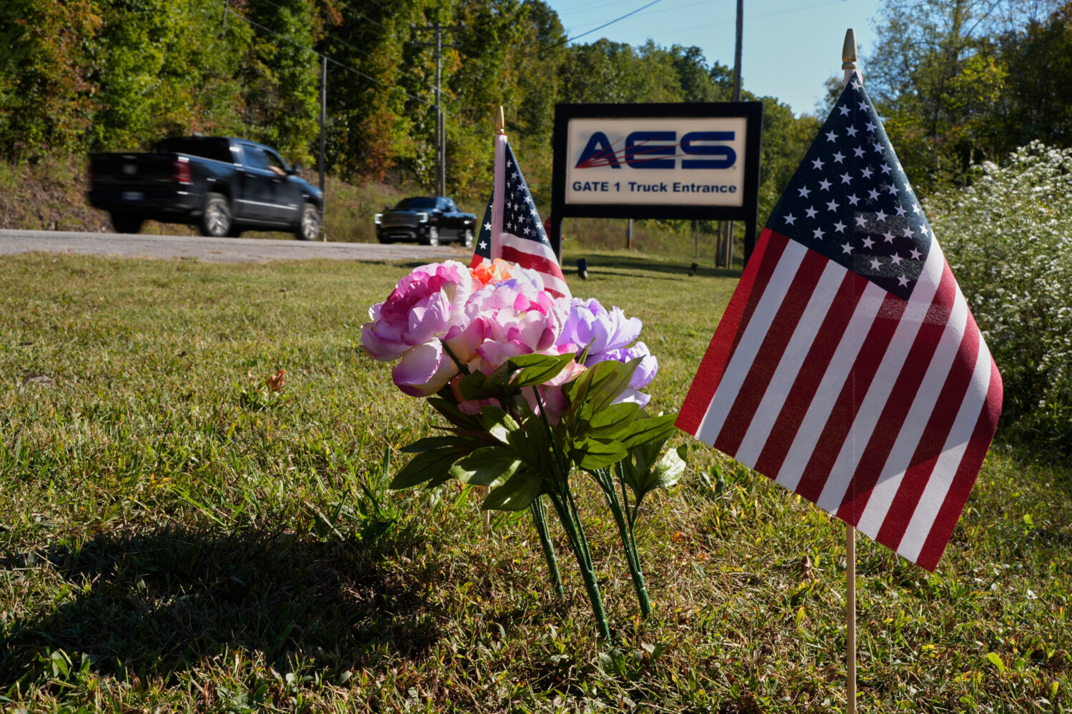 Flowers and flags rest at the entrance to Accurate Energetic Systems after an explosion on Friday, ...