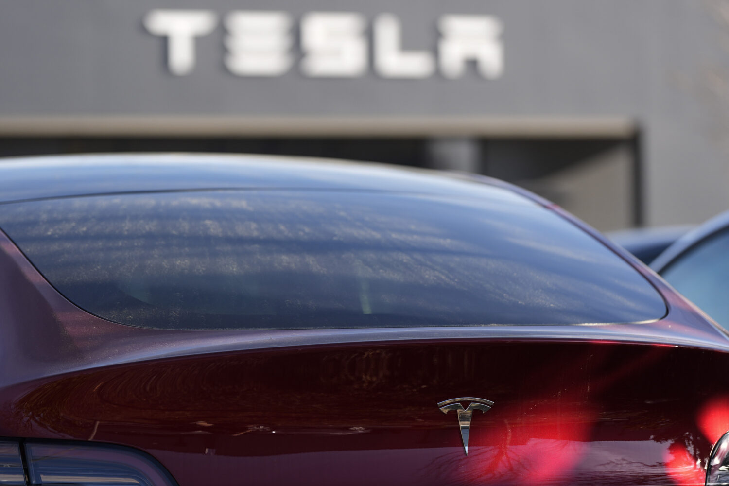 FILE - A Tesla model Y and other Telsla vehicles sit at a dealership, Wednesday, March 19, 2025, in...