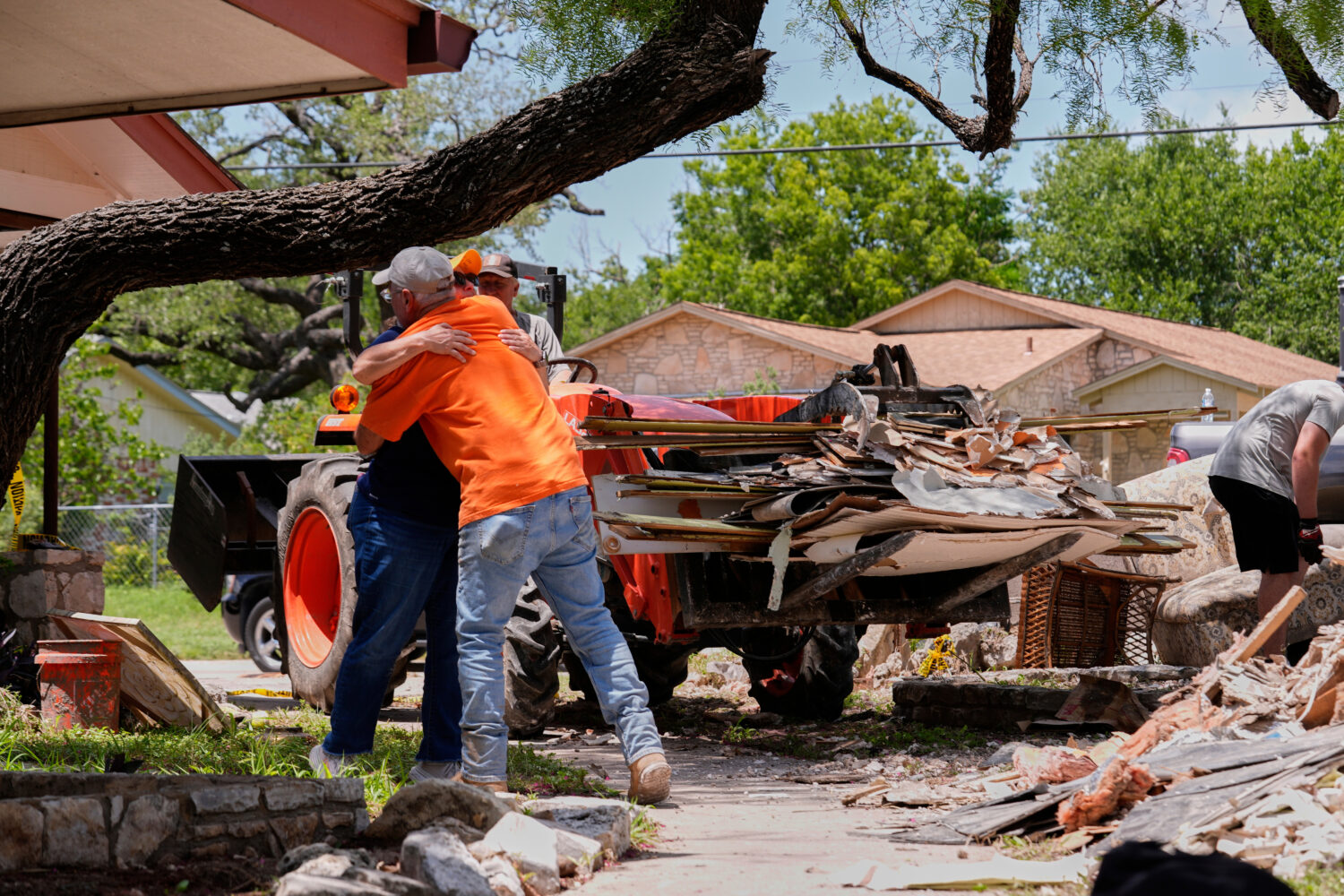 FILE - Homeowner Daniel Olivas hugs Lorrie McMillan, a chaplain with Texans on Mission Disaster Rel...