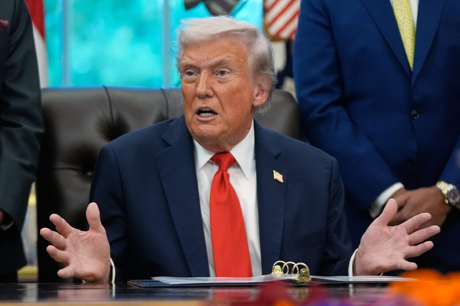 President Donald Trump answers questions from reporters during a Diwali celebration in the Oval Off...