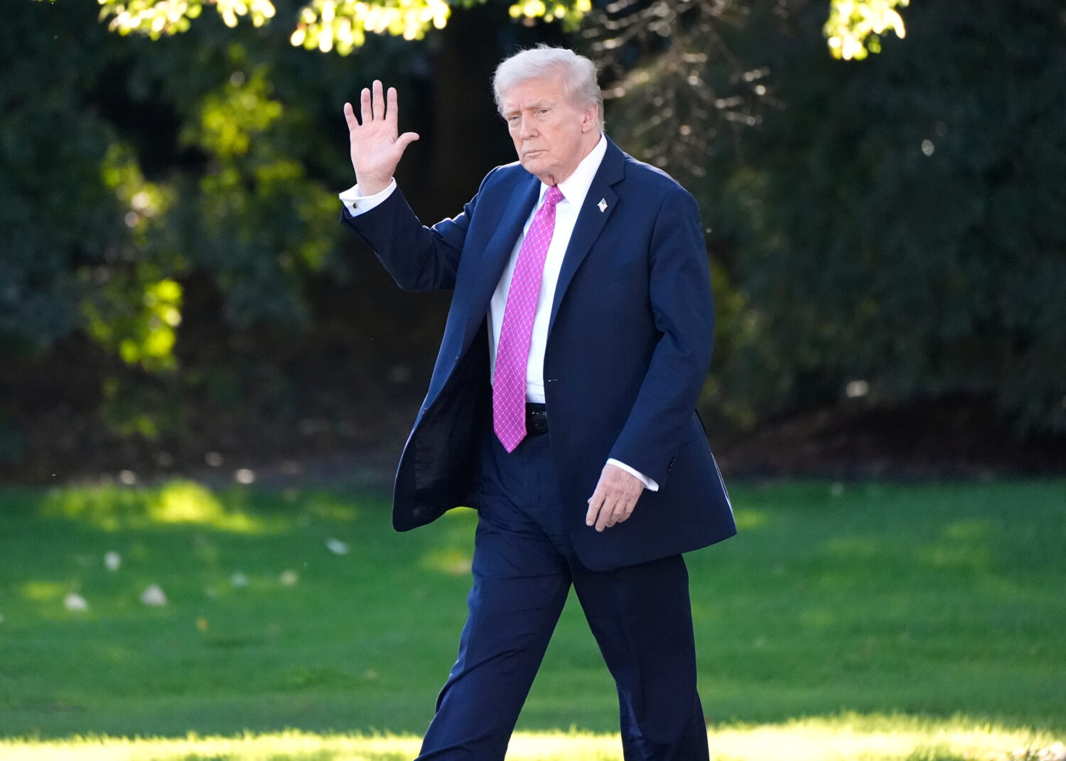 President Donald Trump waves as he walks to board Marine One before departing from the South Lawn o...