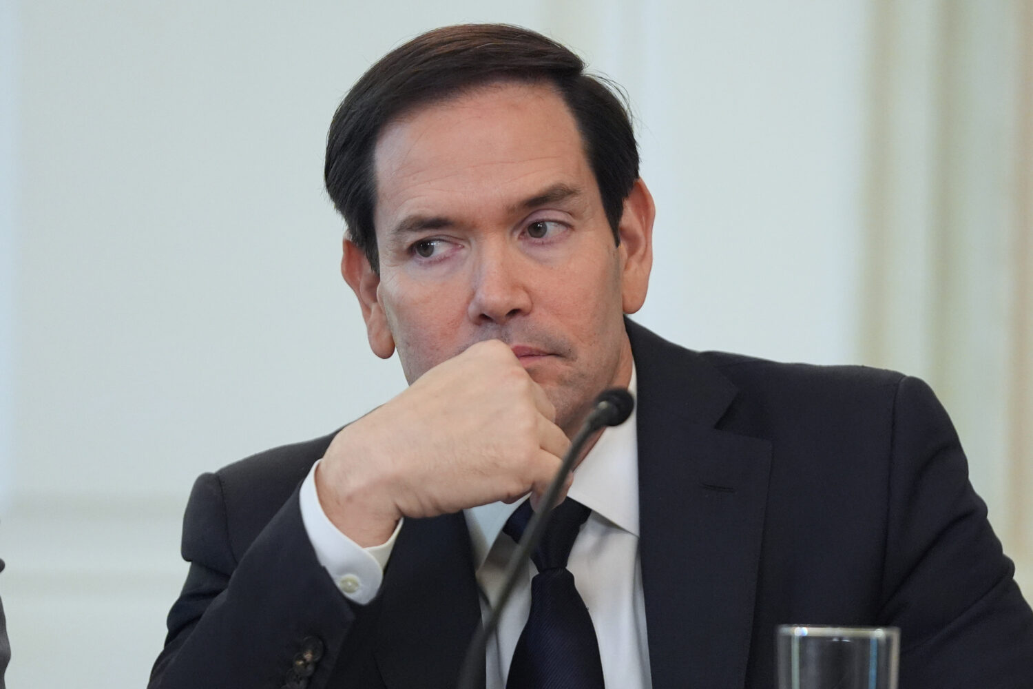 Secretary of State Marco Rubio listens before interrupting President Donald Trump during a roundtab...