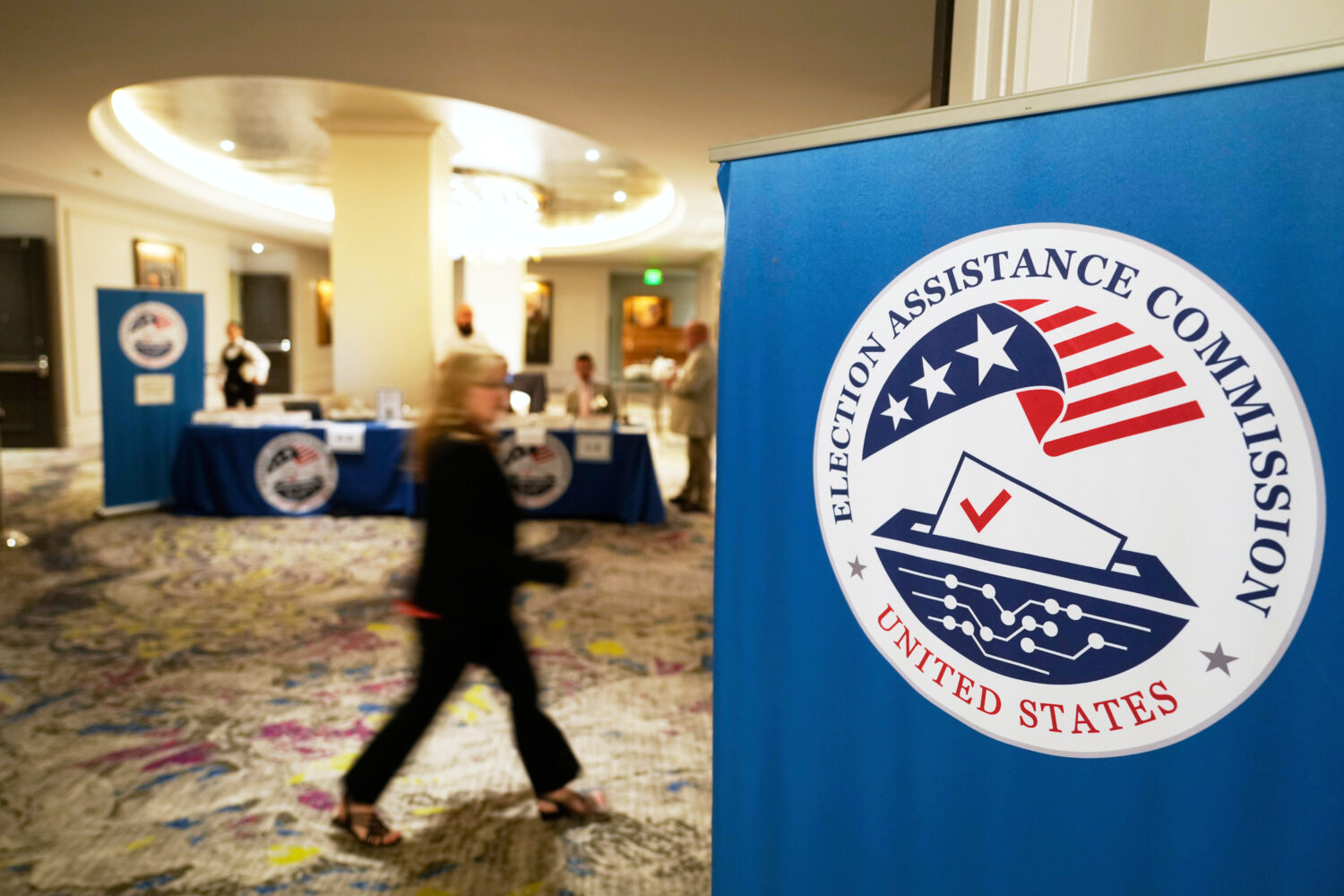 FILE - A person arrives for a U.S. Election Assistance Commission Standards Board public meeting, A...