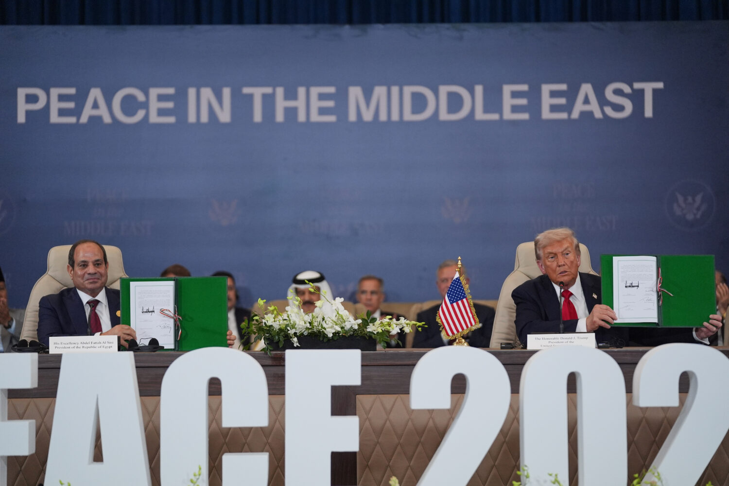 President Donald Trump and Egypt's President Abdel-Fattah el-Sissi hold signed documents during a s...