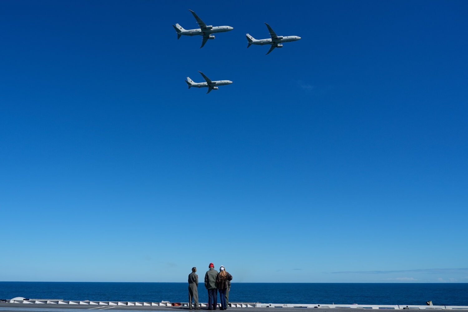 President Donald Trump and first lady Melania Trump watch a flight of P-8A Poseidon aircraft during...