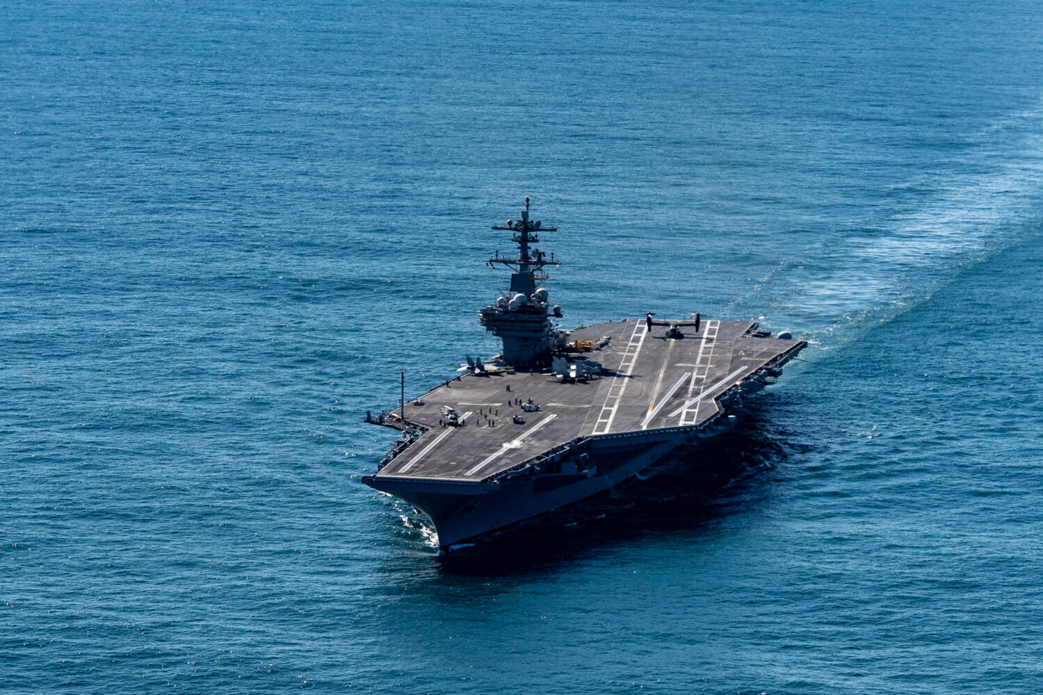The USS George H.W. Bush aircraft carrier sails in the Atlantic Ocean off the coast of Norfolk, Va....