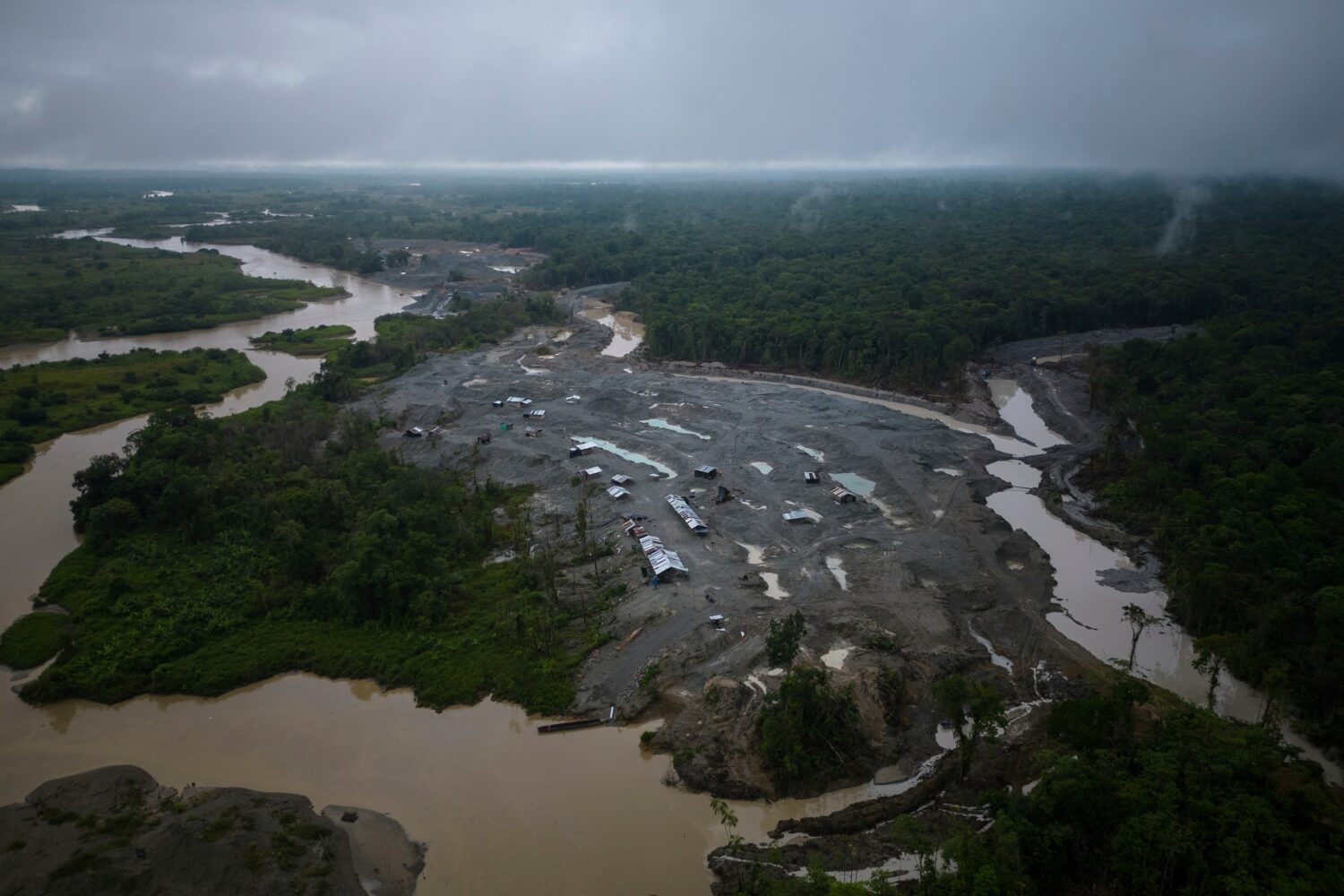 FILE - An illegal mining camp, sits along the Quito River, the Atrato River's main tributary, near ...
