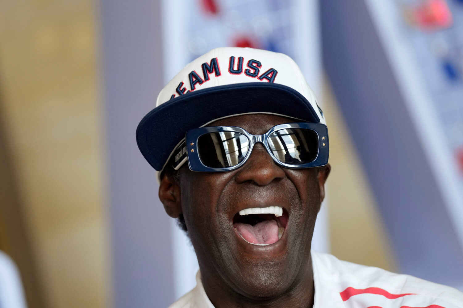FILE - Flavor Flav laughs during an interview with The Associated Press at the USA house at the 202...