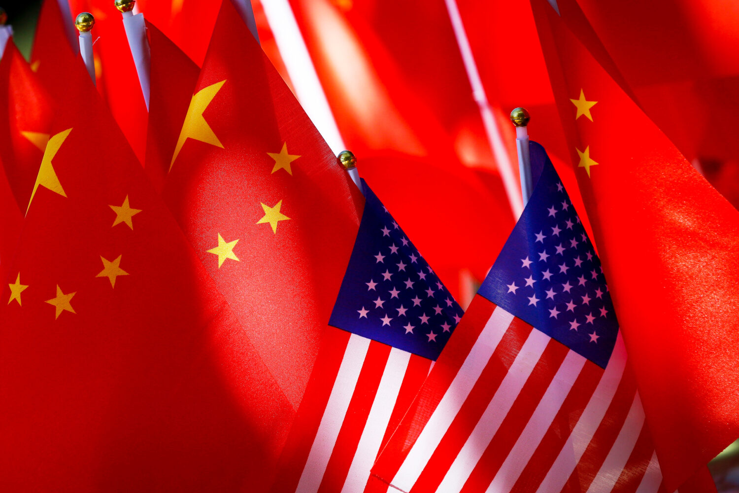 FILE - American flags are displayed with Chinese flags on Sept. 16, 2018, in Beijing. (AP Photo/And...