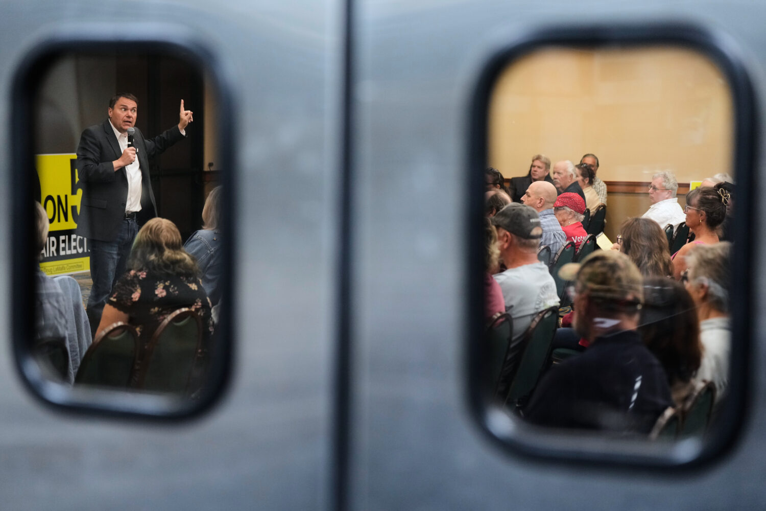 Republican Assemblymember Carl DeMaio, left, speaks to people attending a No on Prop 50 rally in Re...