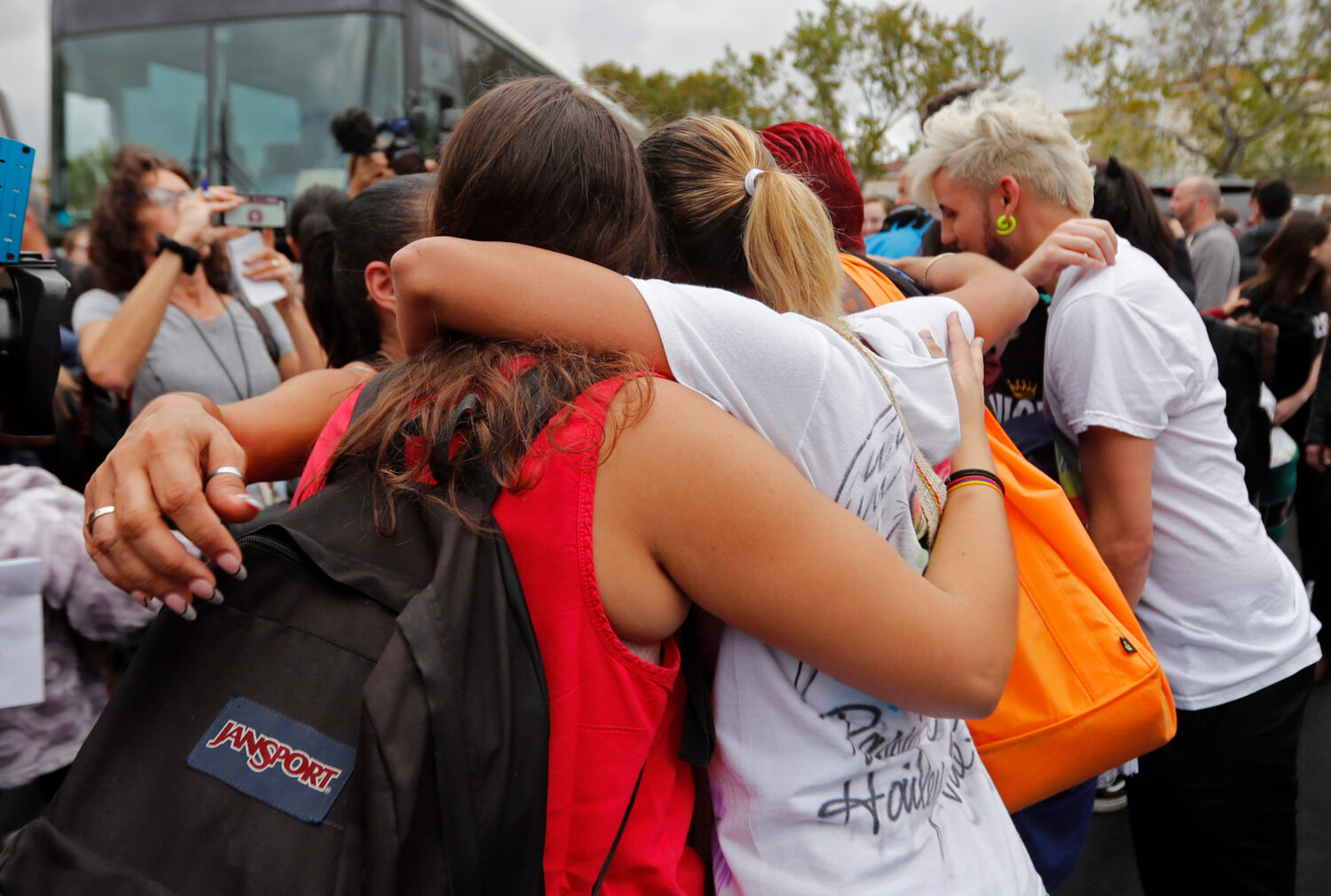 FILE - Students who survived the shooting at Stoneman Douglas High School hug survivors of the Puls...