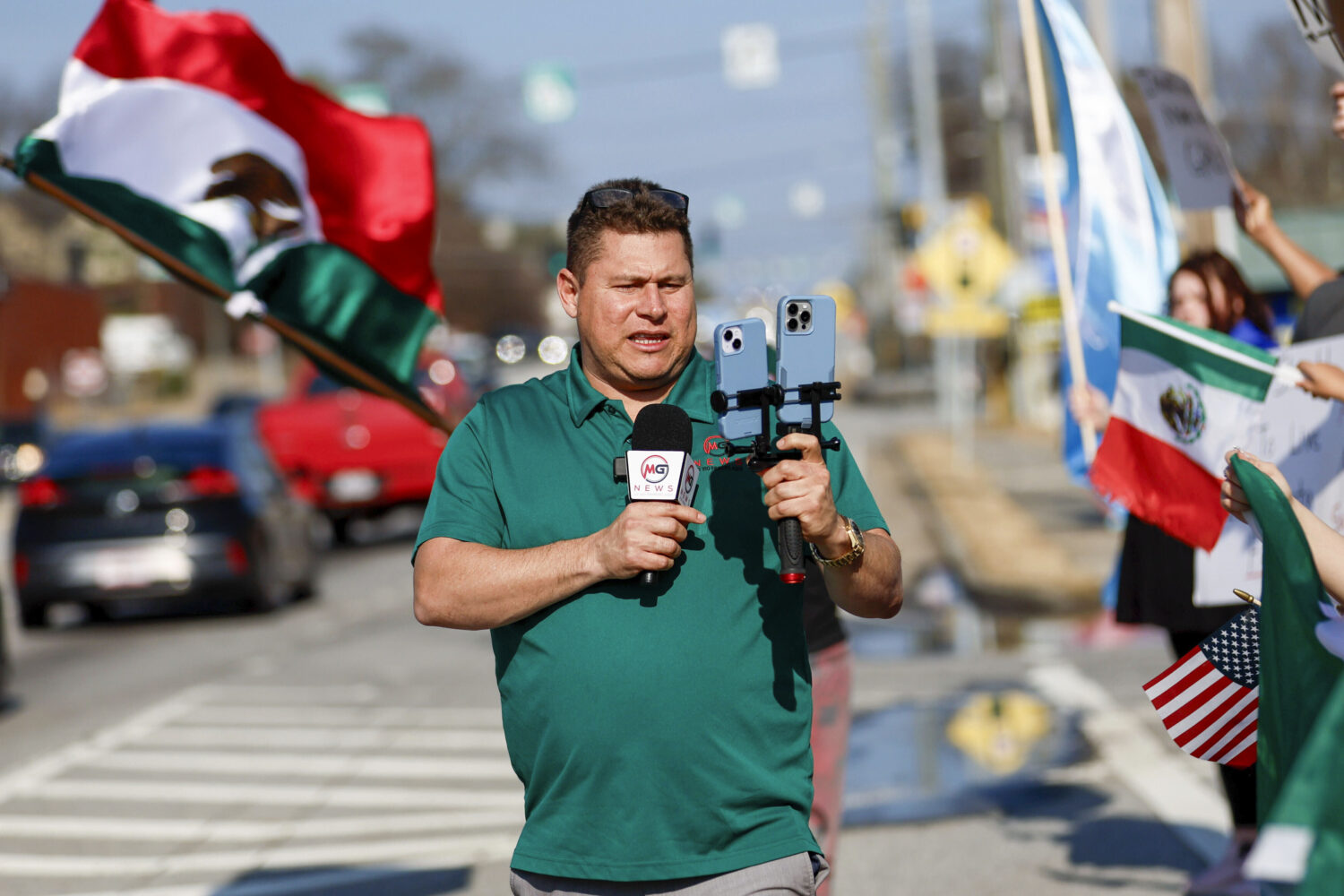 FILE - Mario Guevara, the metro Atlanta-based Spanish-language reporter, covers a protest against i...