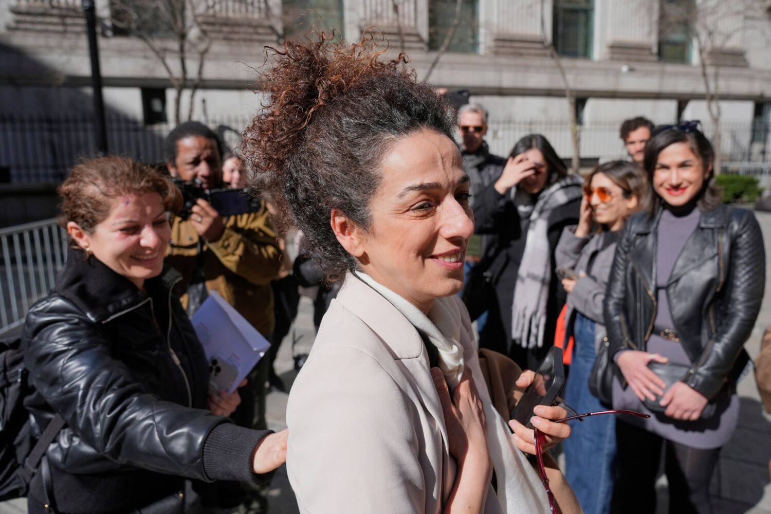 FILE - Masih Alinejad greets friends and supporters outside the federal courthouse after testifying...