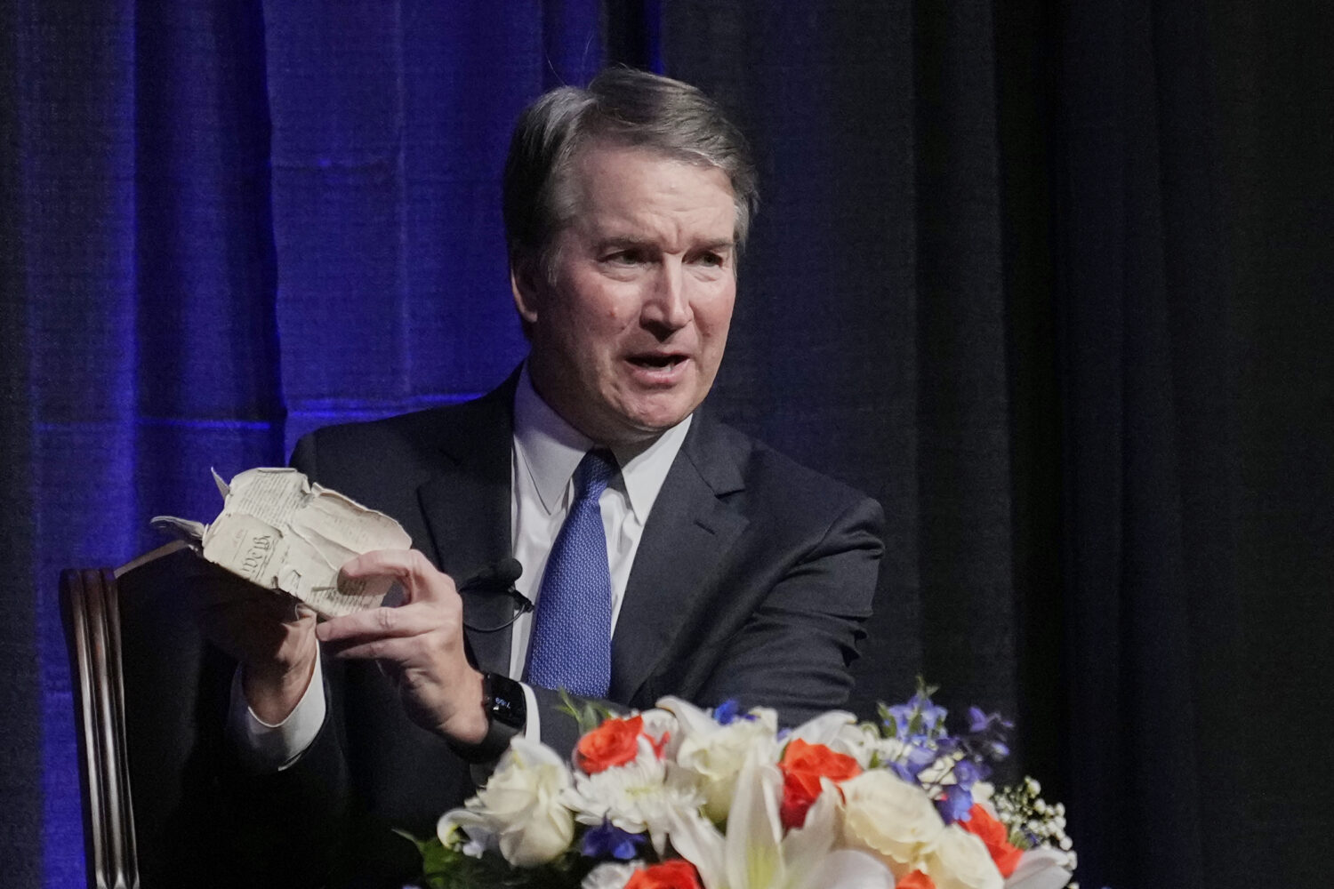 Justice Brett Kavanaugh holds his personal pocket constitution as he speaks at The Ken Starr Lectur...