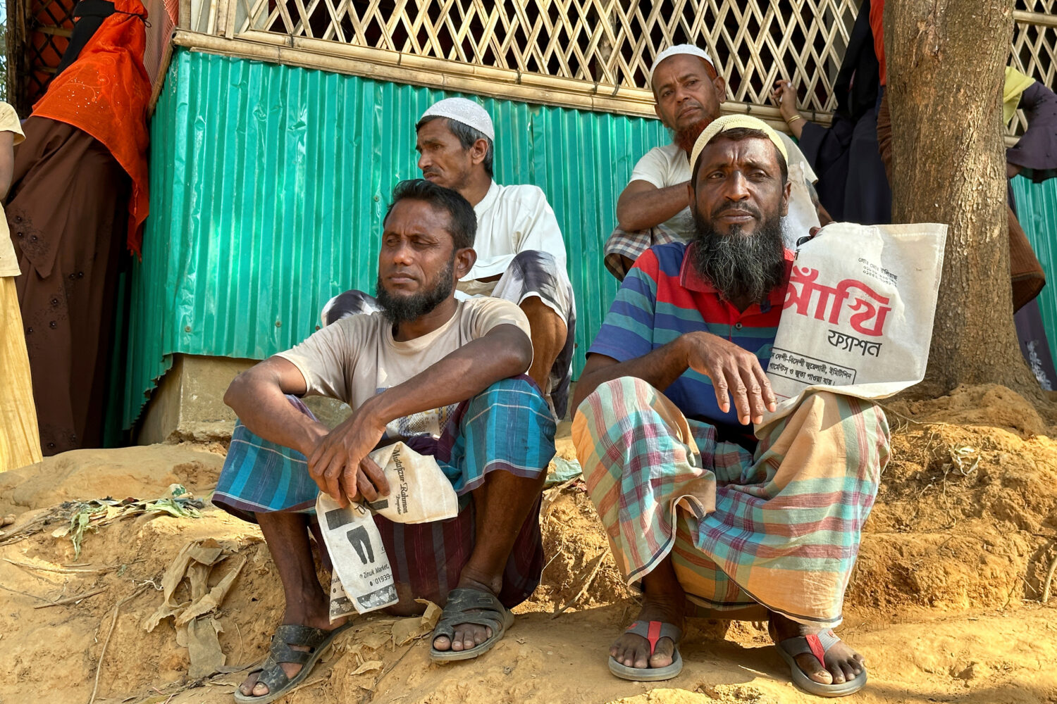 FILE - Rohingya refugees wait for food to be distributed during the Islamic holy month of Ramadan a...