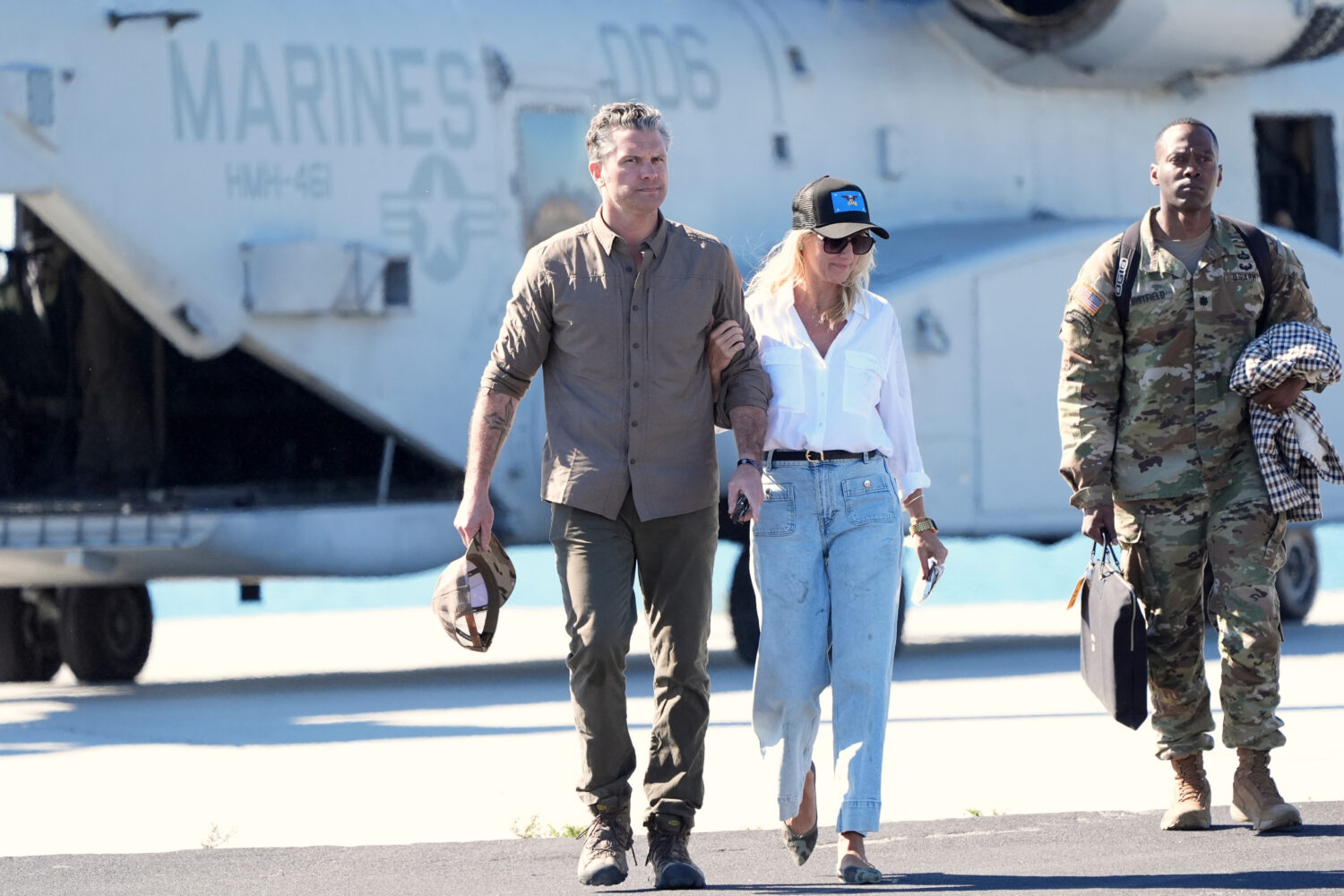 Defense Secretary Pete Hegseth, from left, and his wife Jennifer Rauchet walk during activities to ...