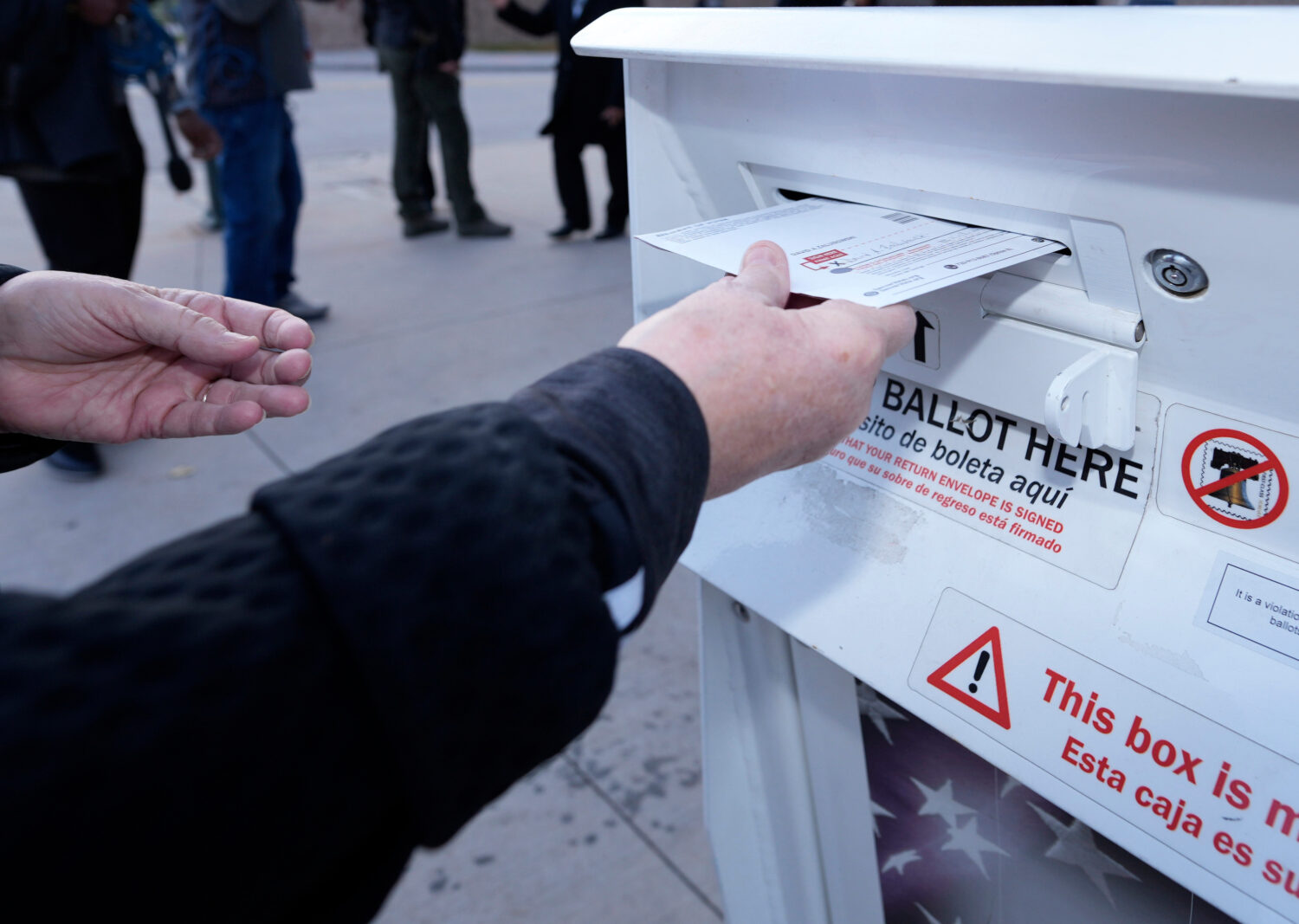 FILE - A voter places a ballot in a drop box outside the Denver Elections Division headquarters, No...