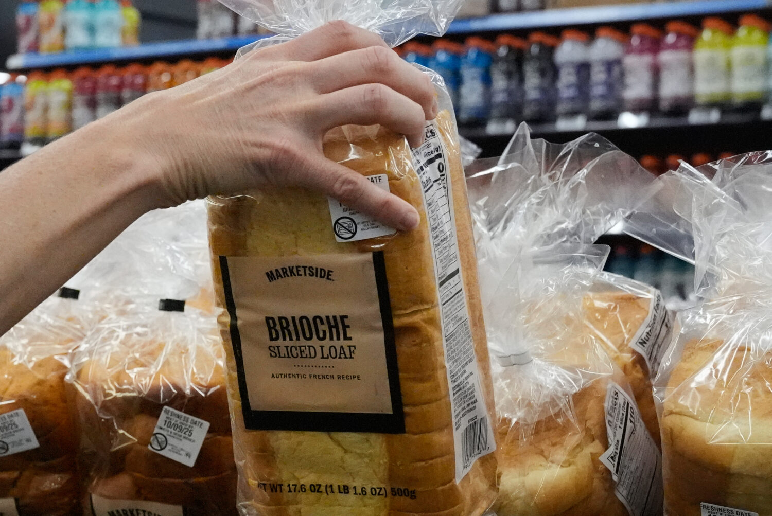 A customer reaches for a loaf of Marketside brand bread at a Walmart Neighborhood Market, Friday, S...