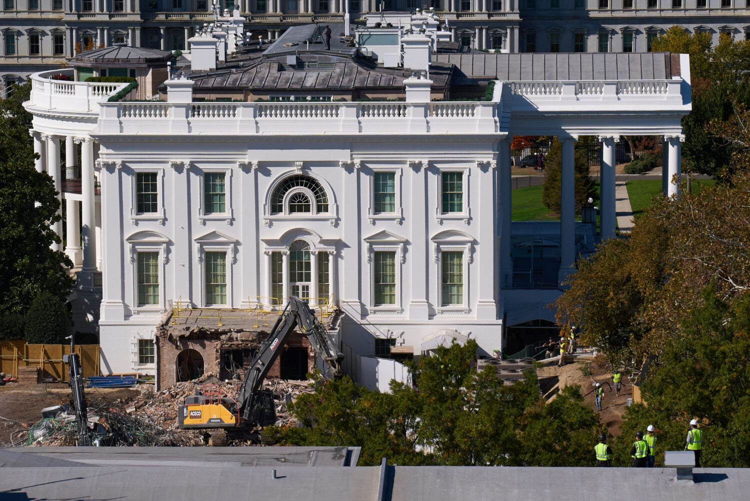 Construction workers atop the U.S. Treasury, bottom right, watch as work continues on a largely dem...
