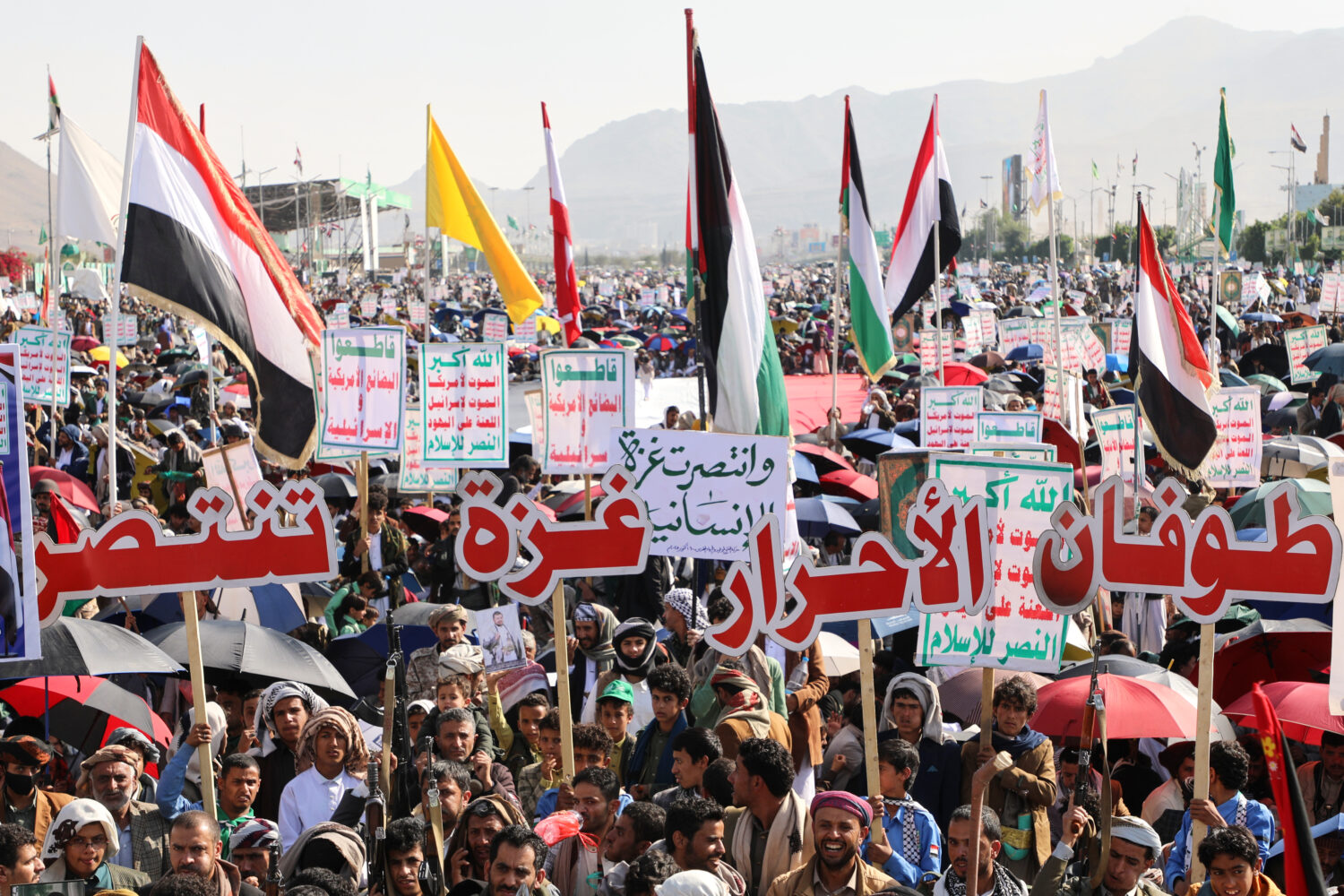 Houthi supporters celebrate following the announcement that Israel and Hamas have agreed to the fir...