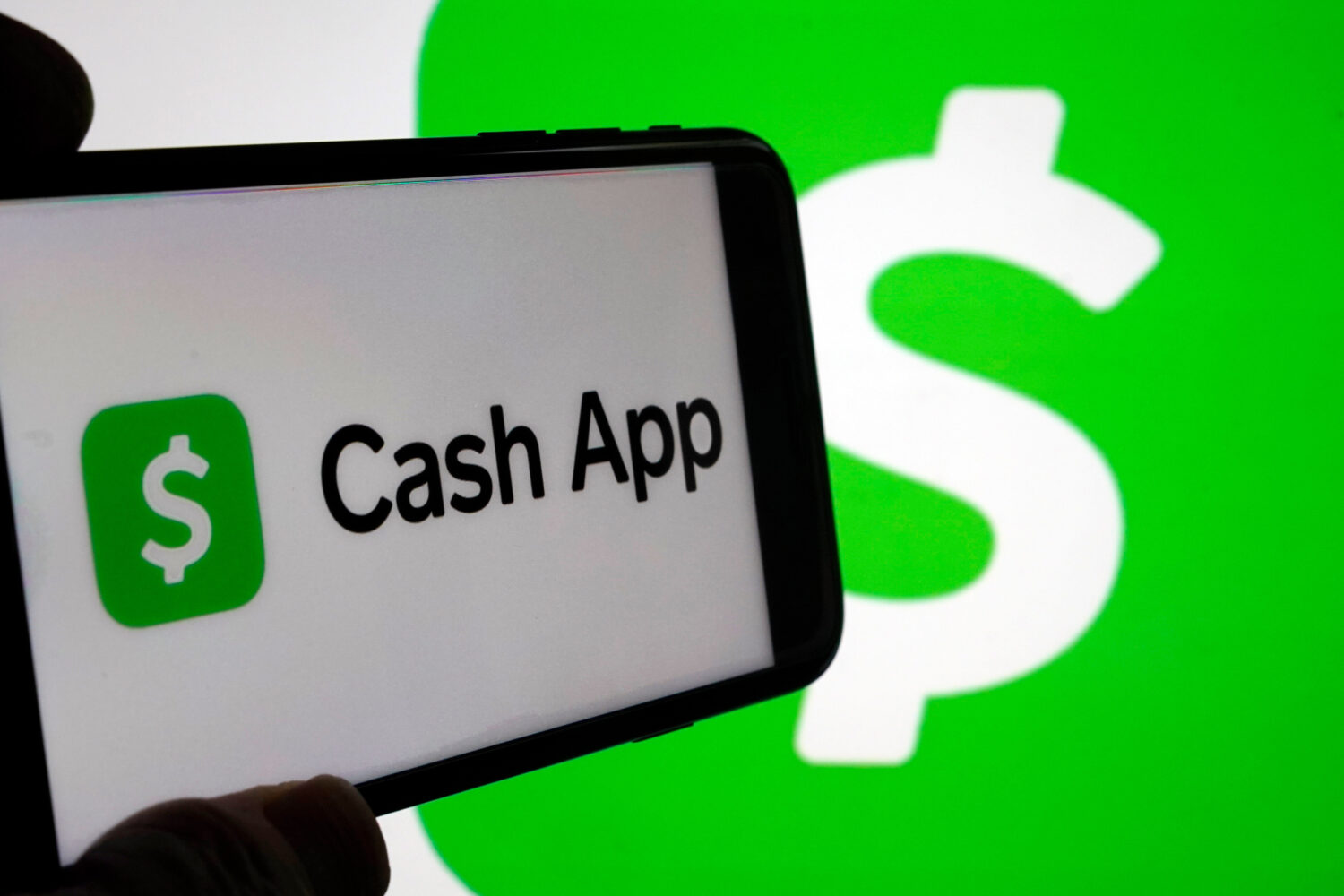 FILE - Cash App logos are seen on a phone screen, Sept. 8, 2023, in New York. (AP Photo/Richard Dre...