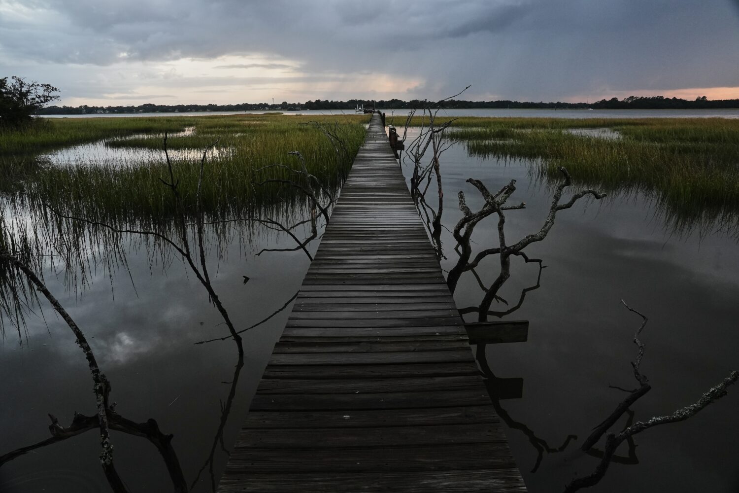 A storm moves through a salt marsh at sunset Monday, Oct. 6, 2025, in Charleston, S.C. (AP Photo/Jo...