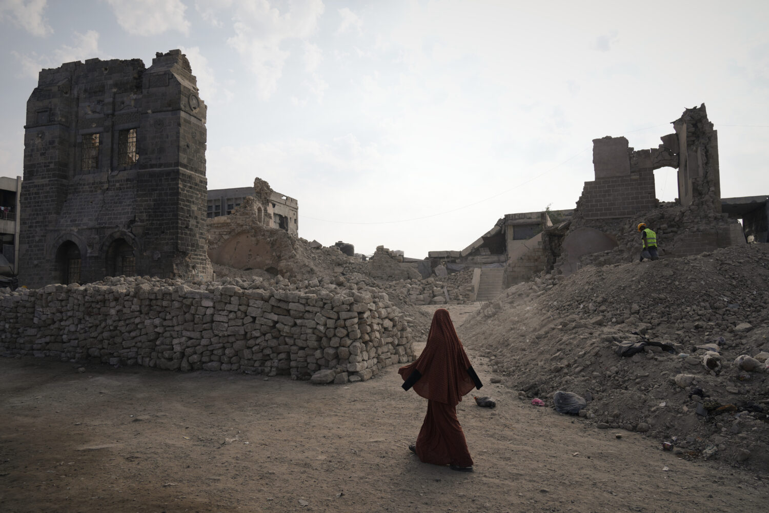 A Palestinian woman walks past the historic Pasha Palace in Gaza City after an Israeli airstrike ba...