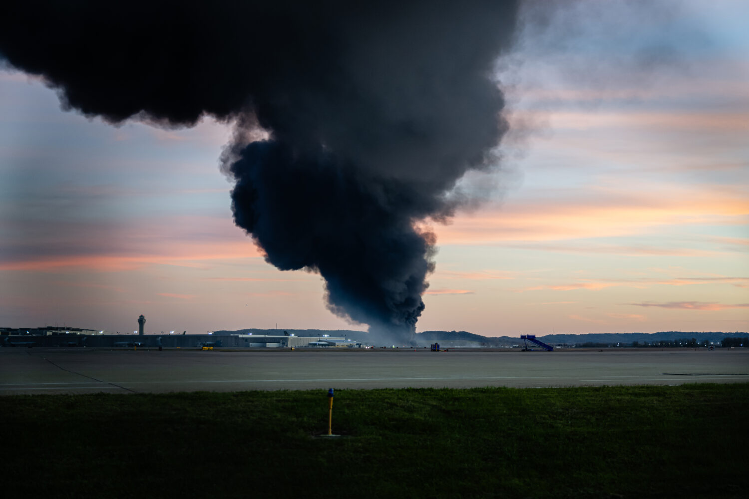A plume of smoke rises from the site of a UPS cargo plane crash at Louisville Muhammad Ali Internat...