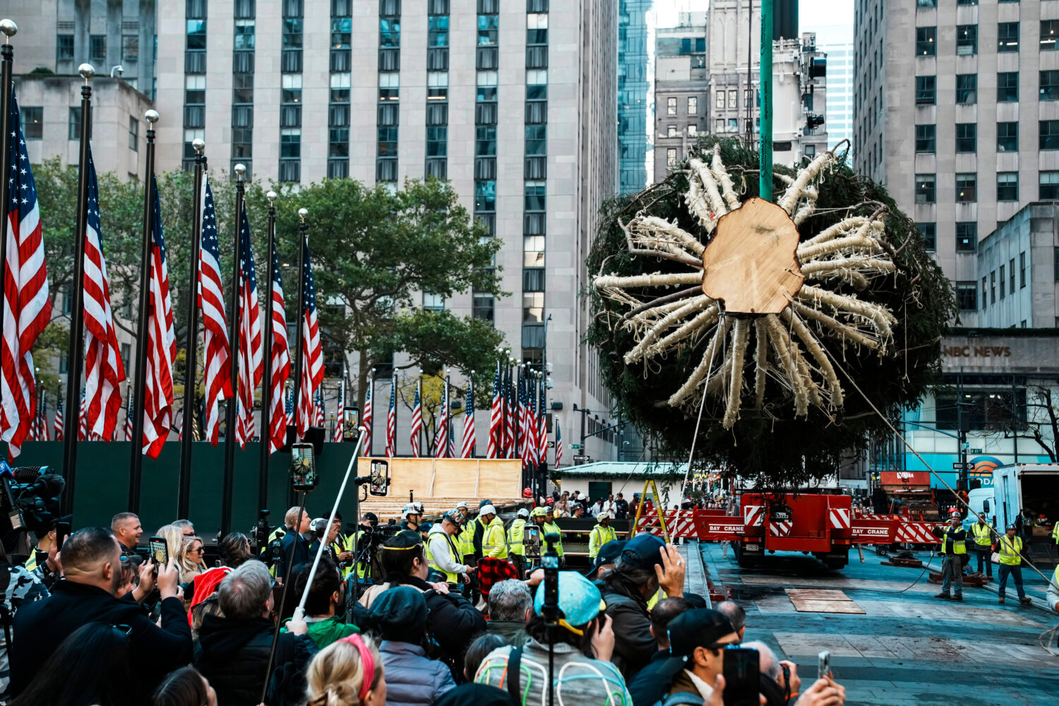 Workers hold the Rockefeller Center Christmas tree with ropes at Rockefeller Plaza, Saturday, Nov. ...