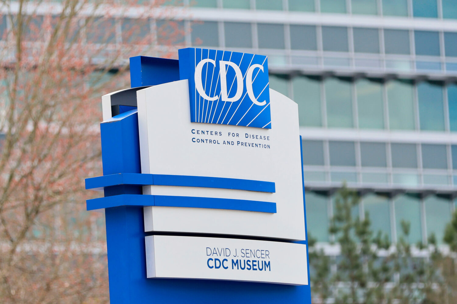 FILE - A sign with the CDC logo is displayed at the entrance to the agency's headquarters in Atlant...