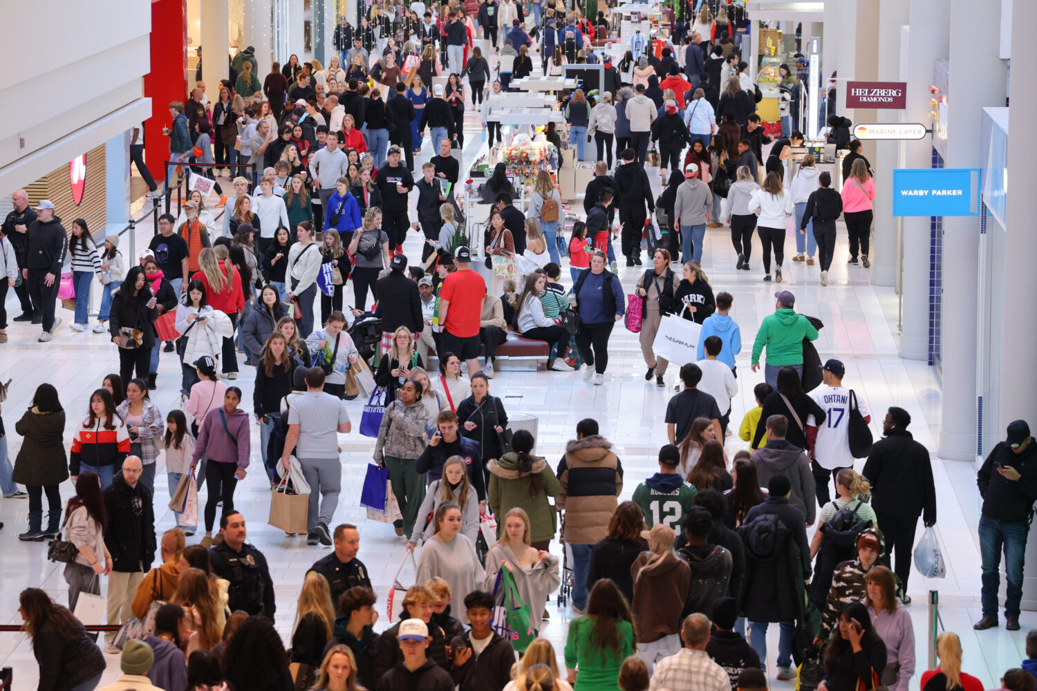 Shoppers browse through stores at Mall of America for Black Friday deals, Friday, Nov. 28, 2025, in...
