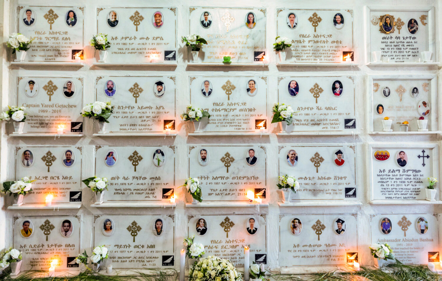 FILE - Candles are lit on a memorial wall during an anniversary service at the Holy Trinity Cathedr...