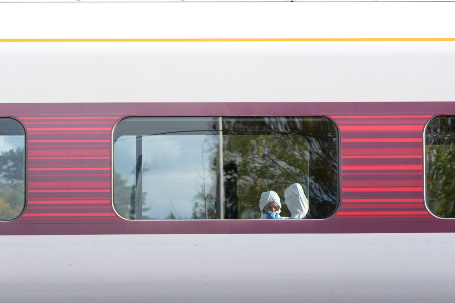 Forensic investigators are seen at the train after a mass stabbing on a London-bound train in Hunti...