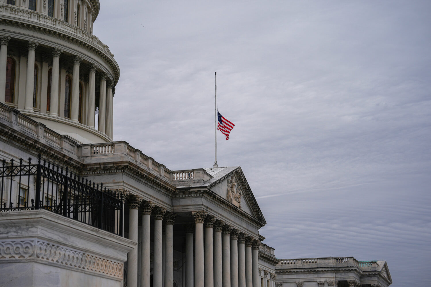 The American flag flies half-staff outside the U.S. Capitol, Tuesday, Nov. 18, 2025, in Washington....