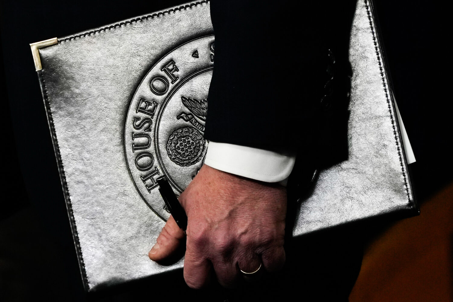 Speaker of the House Mike Johnson, R-La., holds a folder during a news conference on the Epstein Fi...