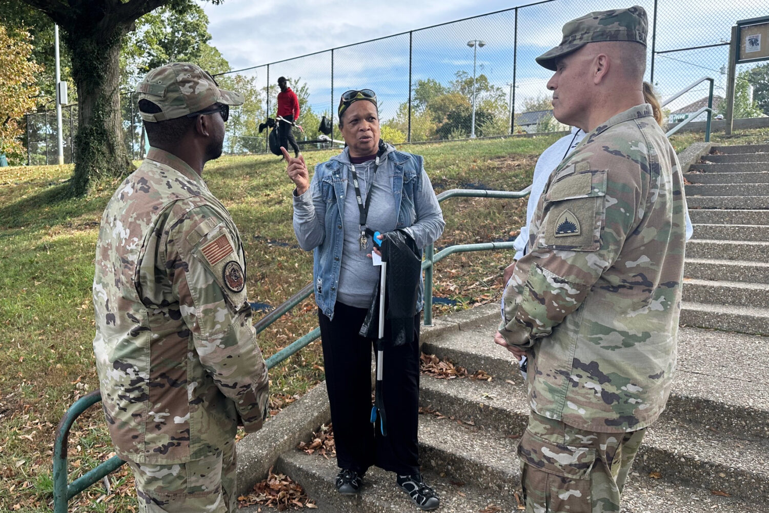 Neighborhood resident and volunteer, Valencia Mohammed, center, talks to D.C. National Guard interi...