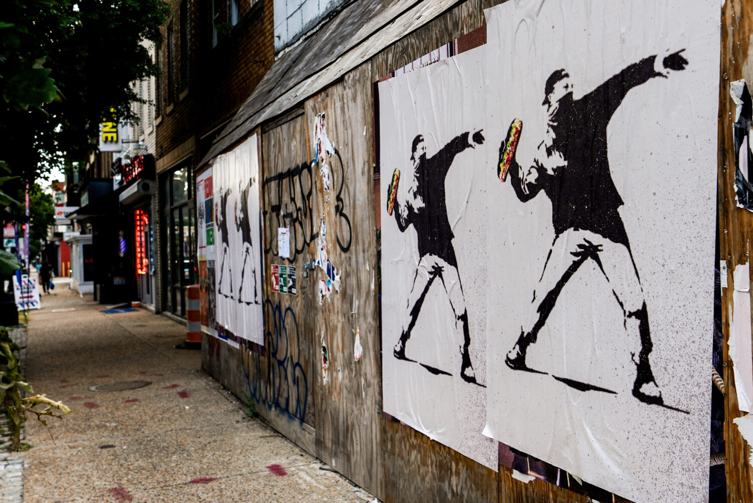 FILE - Posters of a person throwing a sandwich are pictured along H Street, Aug. 17, 2025, in Washi...