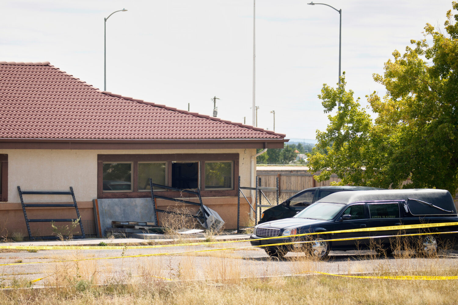 FILE - A hearse and van sit outside the Return to Nature Funeral Home in Penrose, Colo., on Oct. 6,...